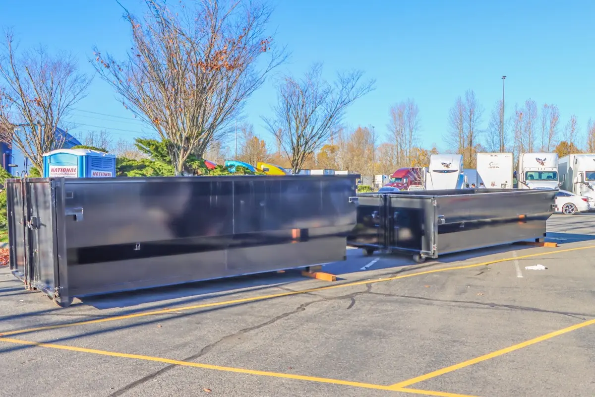 Professional dumpster rental service with roll-off container on residential driveway in Lemoore